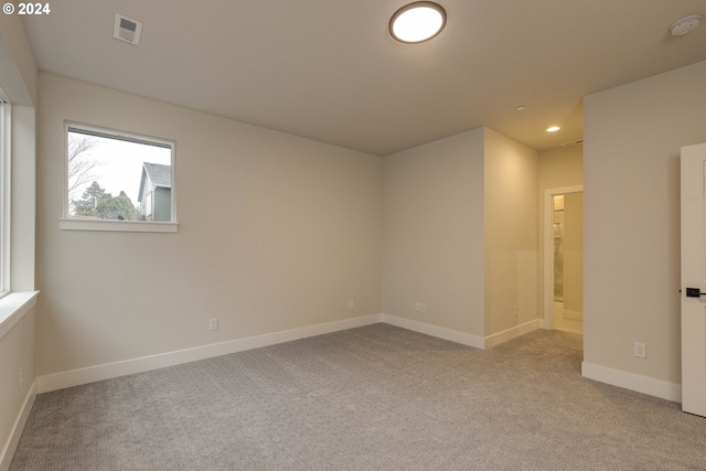 unfurnished room with light carpet