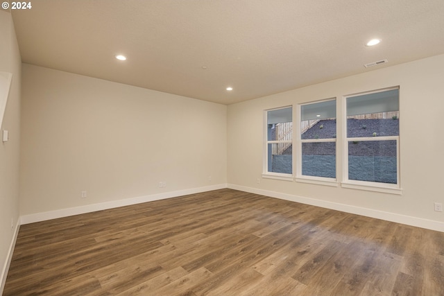 spare room featuring wood-type flooring