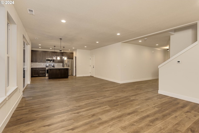 unfurnished living room with hardwood / wood-style flooring