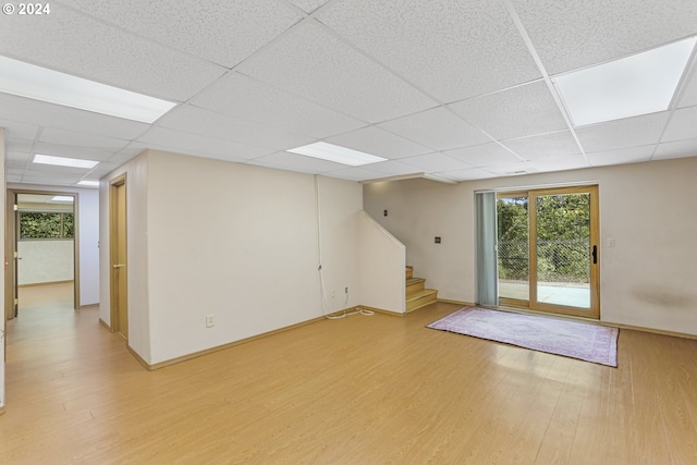 basement featuring hardwood / wood-style flooring and a drop ceiling