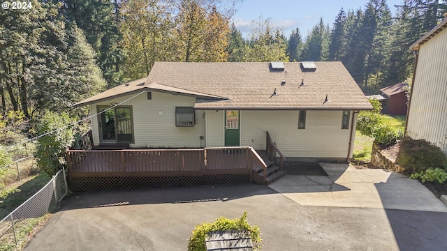 back of house featuring a wooden deck