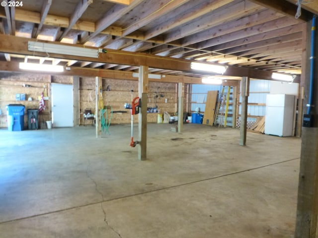 basement with white refrigerator