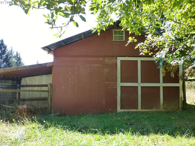 view of outbuilding featuring a lawn