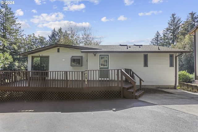 back of property with a wooden deck