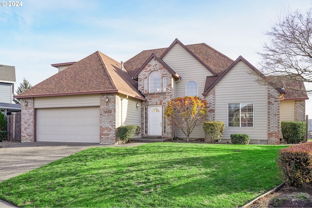 view of property with a front lawn and a garage