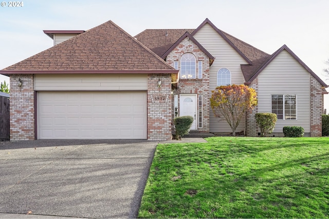 view of front of property with a front yard and a garage