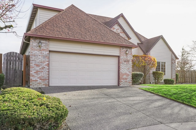 view of front of home featuring a garage and a front lawn