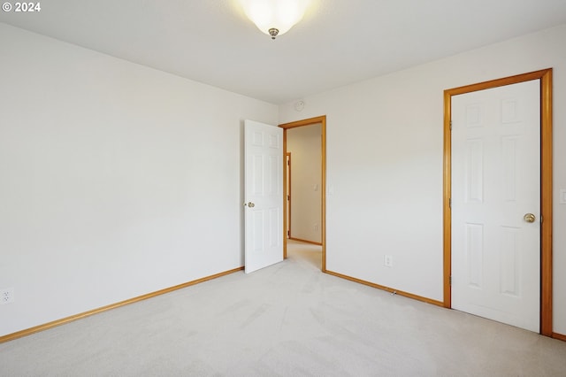 spare room featuring light colored carpet