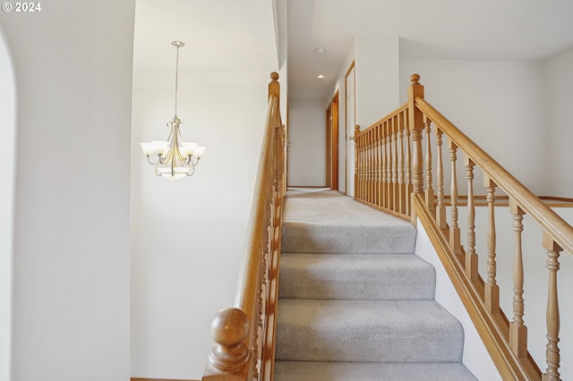 stairway with an inviting chandelier