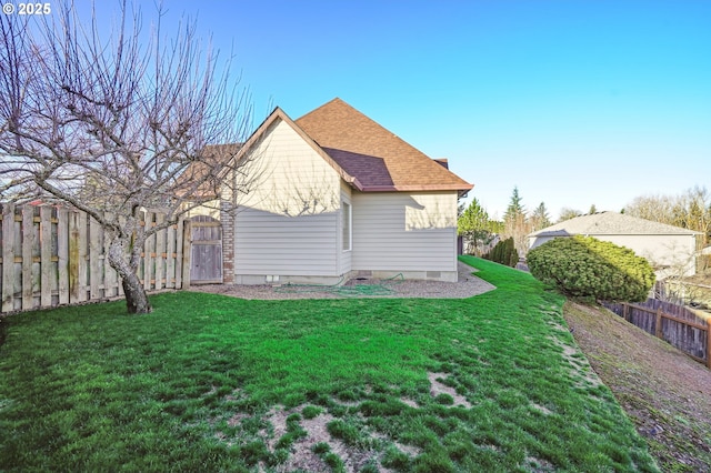 view of side of property with a lawn