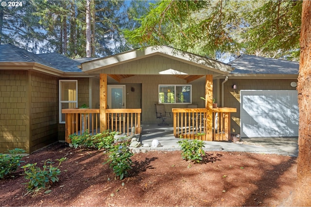 exterior space featuring a garage and covered porch