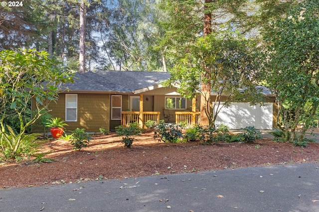 view of front facade with a garage and a wooden deck