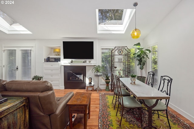 living room featuring french doors, lofted ceiling, and hardwood / wood-style floors