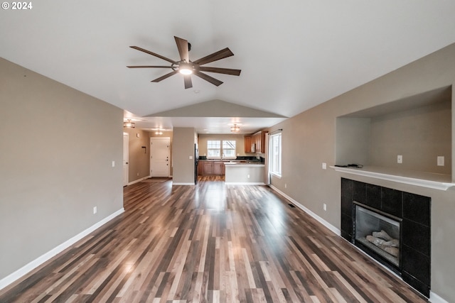 unfurnished living room featuring ceiling fan, a fireplace, dark hardwood / wood-style floors, and lofted ceiling