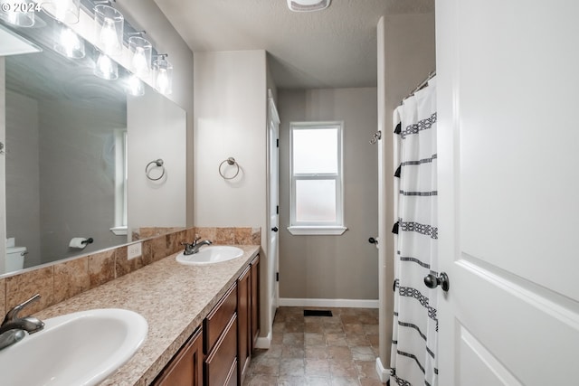 bathroom featuring vanity and a textured ceiling