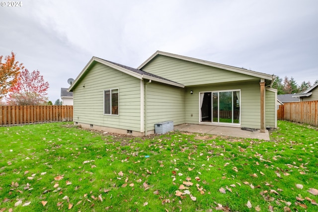 back of property featuring a patio area and a lawn