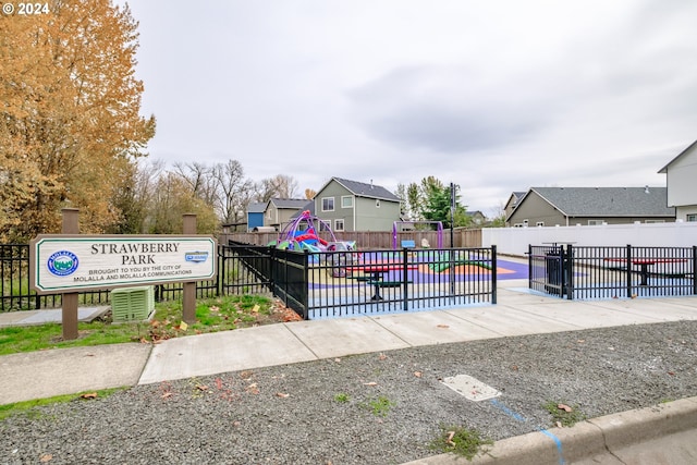 view of home's community featuring fence and playground community