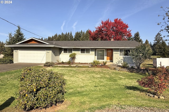 ranch-style home with a front yard and a garage