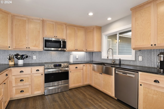 kitchen with appliances with stainless steel finishes, sink, dark wood-type flooring, and light brown cabinetry