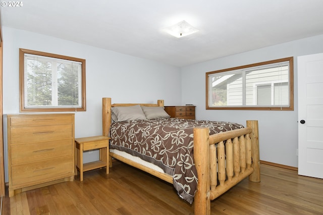 bedroom with dark hardwood / wood-style floors