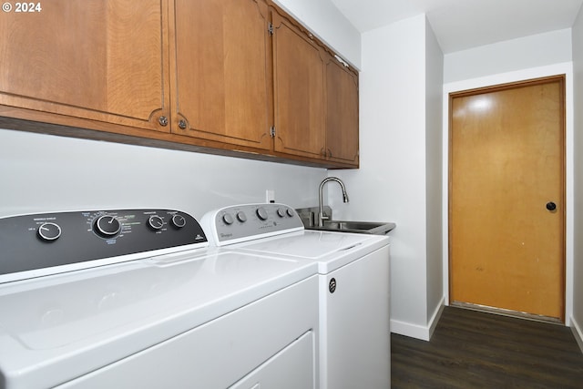 clothes washing area featuring sink, dark hardwood / wood-style floors, separate washer and dryer, and cabinets