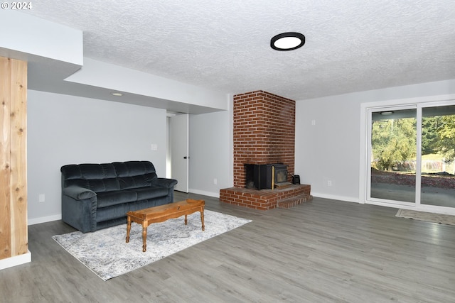 living room featuring dark wood-type flooring and a textured ceiling