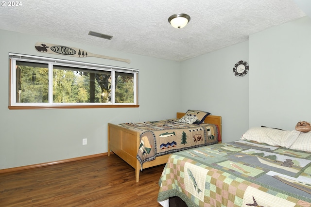 34603 SE Jarl Rd, Boring, OR 97009 - bedroom featuring wood finished floors, a textured ceiling, and baseboards