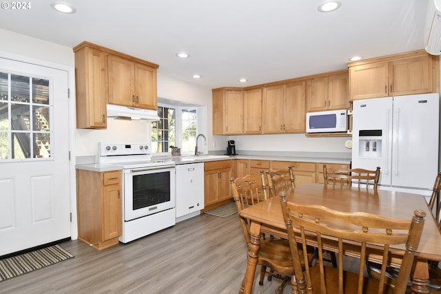 kitchen featuring white appliances, light hardwood / wood-style floors, sink, and light brown cabinets