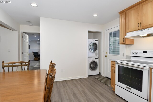 34603 SE Jarl Rd, Boring, OR 97009 - kitchen with white electric range oven, stacked washing machine and dryer, under cabinet range hood, light wood-style flooring, and recessed lighting