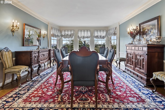 dining space featuring crown molding and hardwood / wood-style flooring