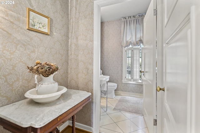 bathroom with toilet, tile floors, and vanity