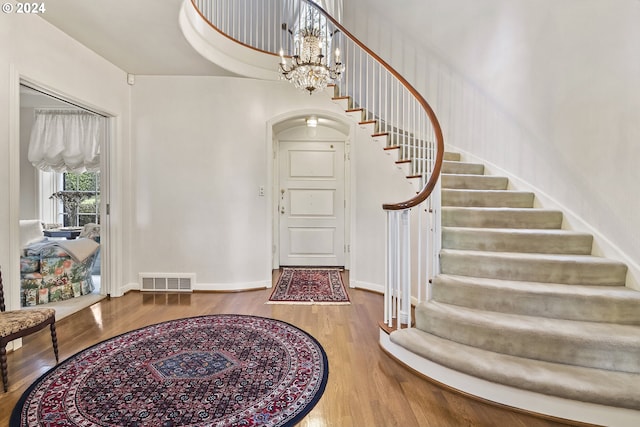 entrance foyer with light hardwood / wood-style flooring and a chandelier