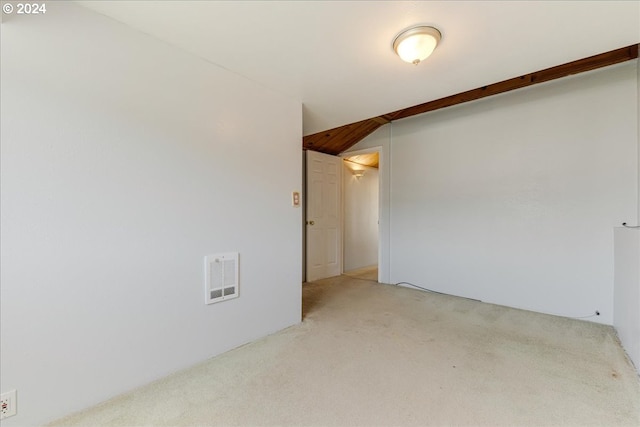 unfurnished room featuring light carpet