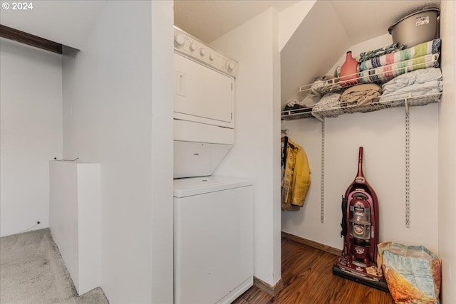 laundry area featuring stacked washing maching and dryer and wood-type flooring