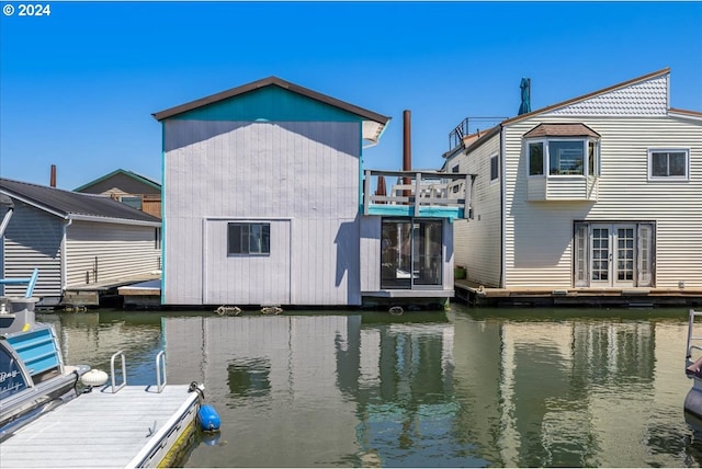 view of dock featuring a water view and a balcony