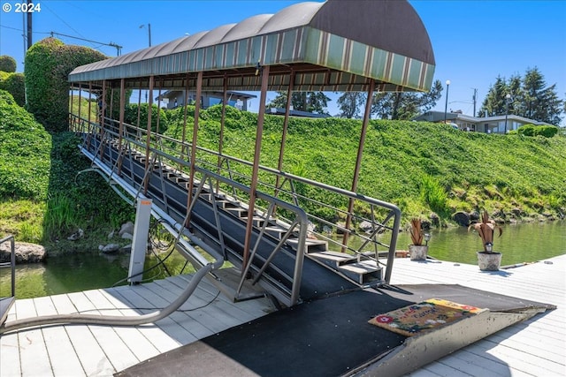 exterior space featuring a boat dock and a water view