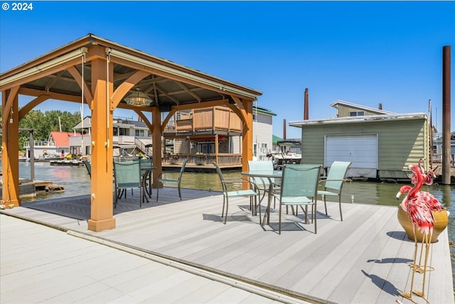 wooden terrace with a water view and a boat dock