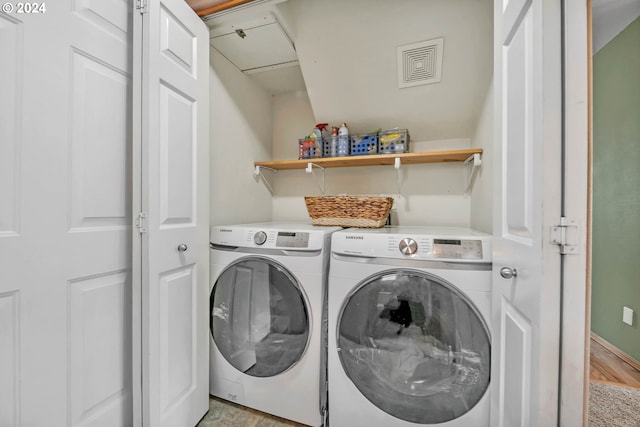 laundry area featuring washer and clothes dryer and light wood-type flooring