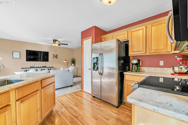 kitchen featuring light brown cabinetry, sink, light hardwood / wood-style flooring, and stainless steel appliances