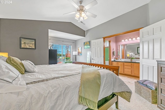 carpeted bedroom featuring ensuite bath, lofted ceiling, sink, and ceiling fan