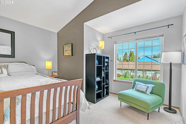 carpeted bedroom with lofted ceiling