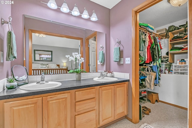 bathroom with vanity and a textured ceiling