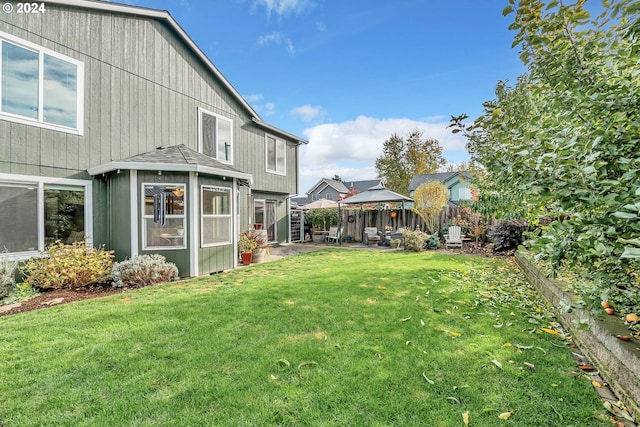 view of yard with a sunroom, a gazebo, and a patio