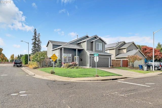 view of front of house with a garage and a front lawn