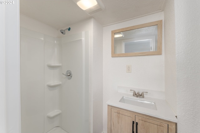 bathroom with vanity and walk in shower