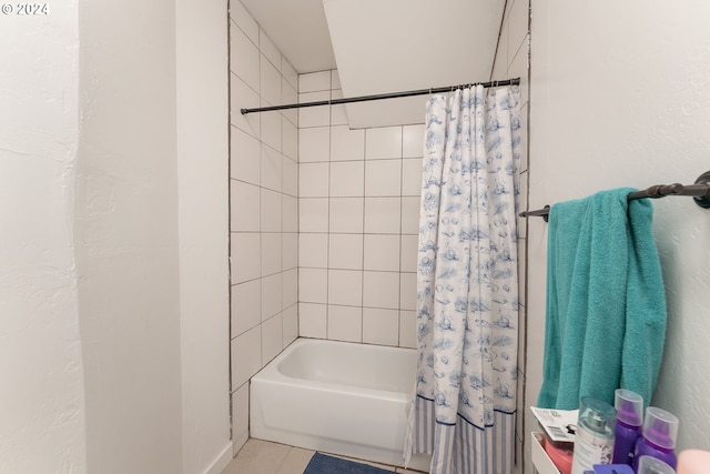 bathroom with tile patterned flooring and shower / bath combo