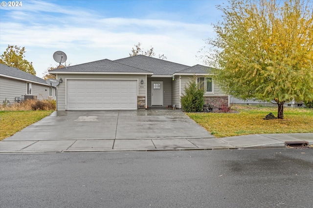 view of front of house with a garage and a front lawn