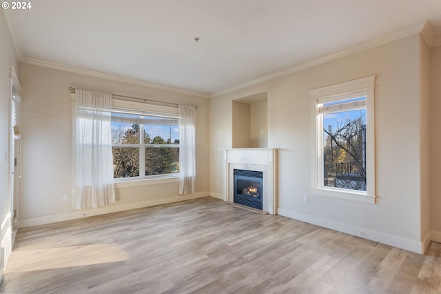 unfurnished living room featuring light hardwood / wood-style floors and ornamental molding