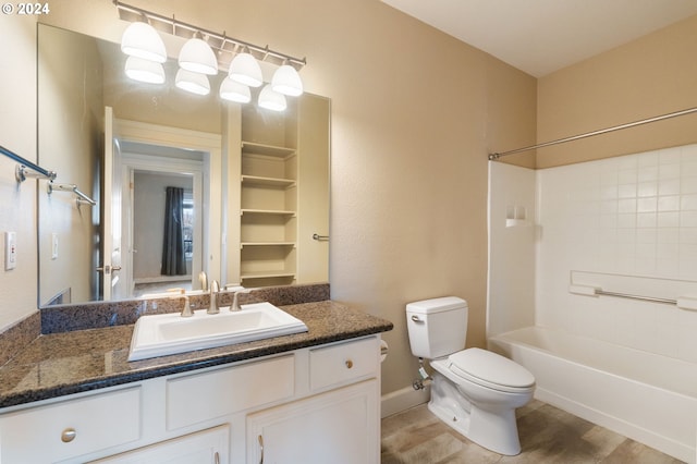 full bathroom with washtub / shower combination, vanity, hardwood / wood-style flooring, and toilet