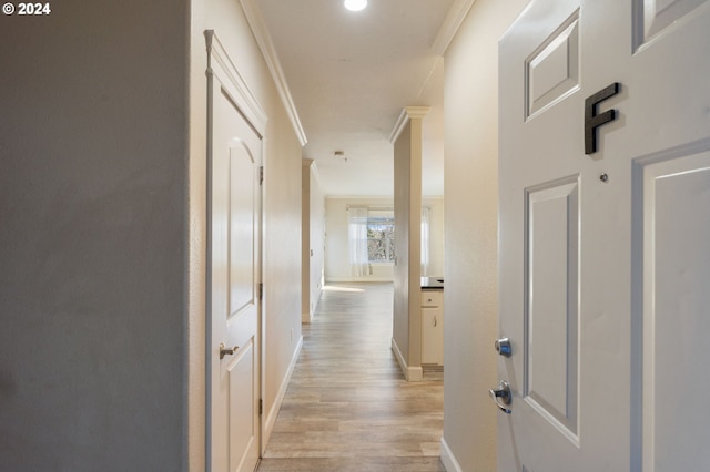 hall featuring light hardwood / wood-style floors and ornamental molding